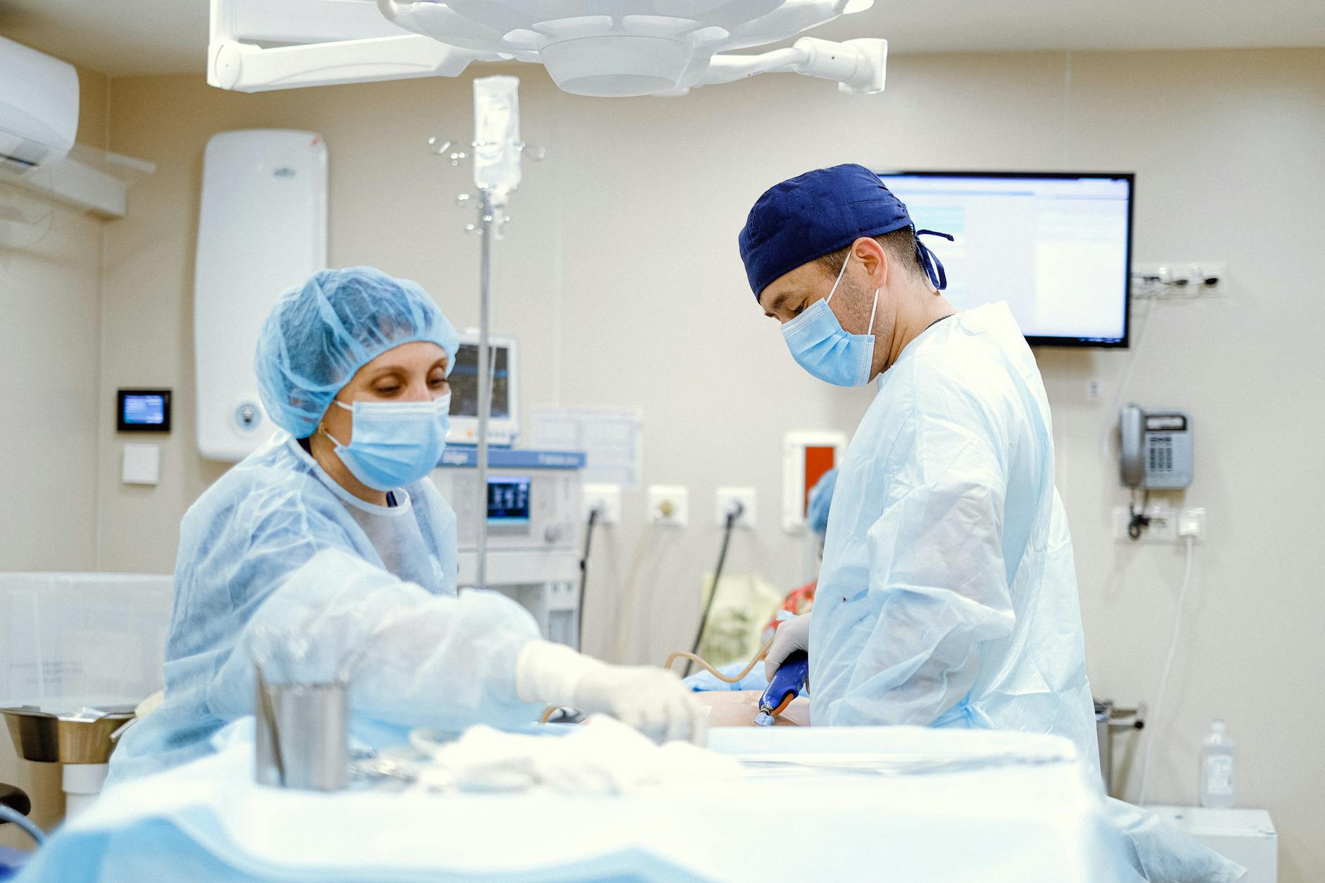 nurse and surgeon working in operating room