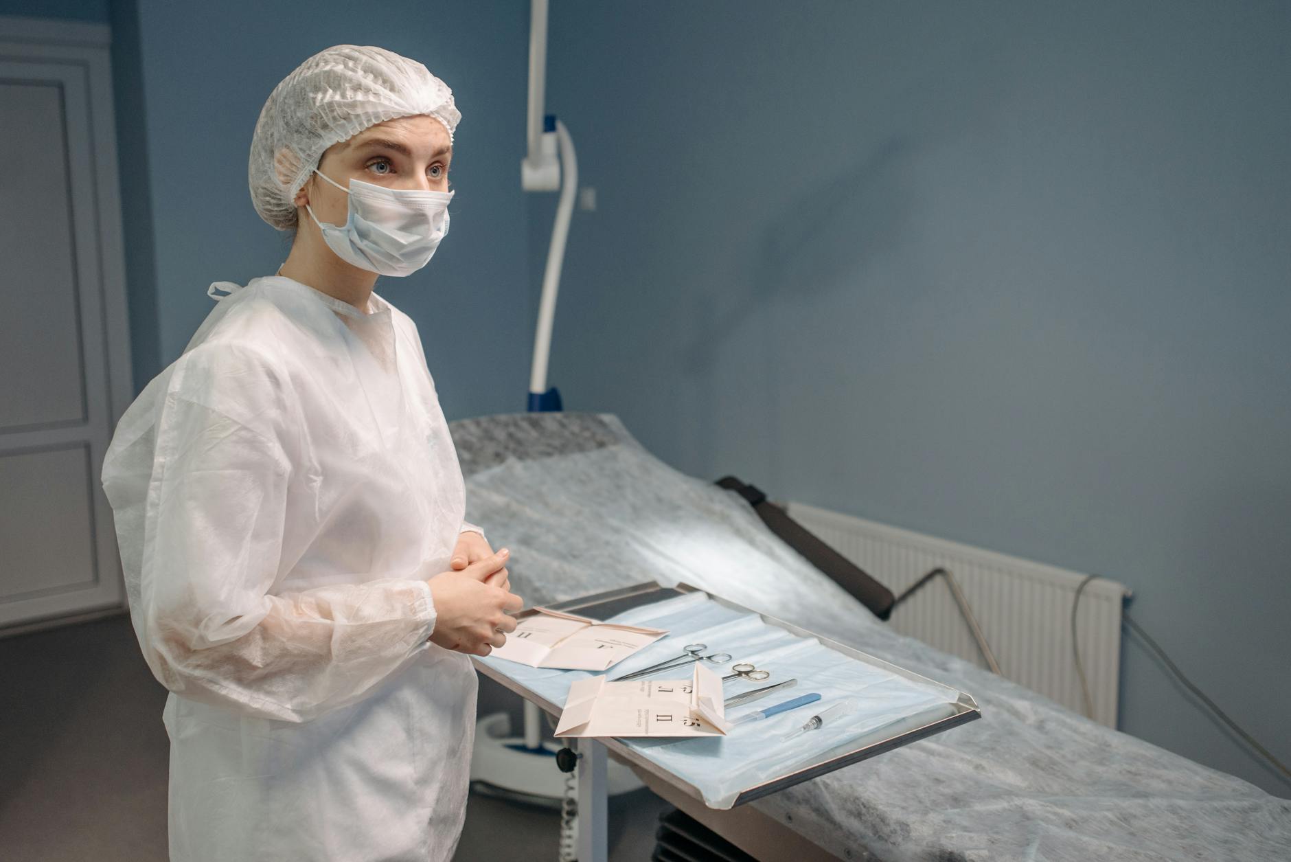 woman in white protective suit waiting inside a room